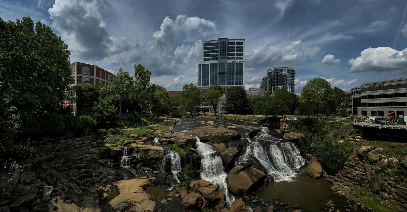Falls Park on the Reedy, with the downtown Greenville skyline behind the waterfall